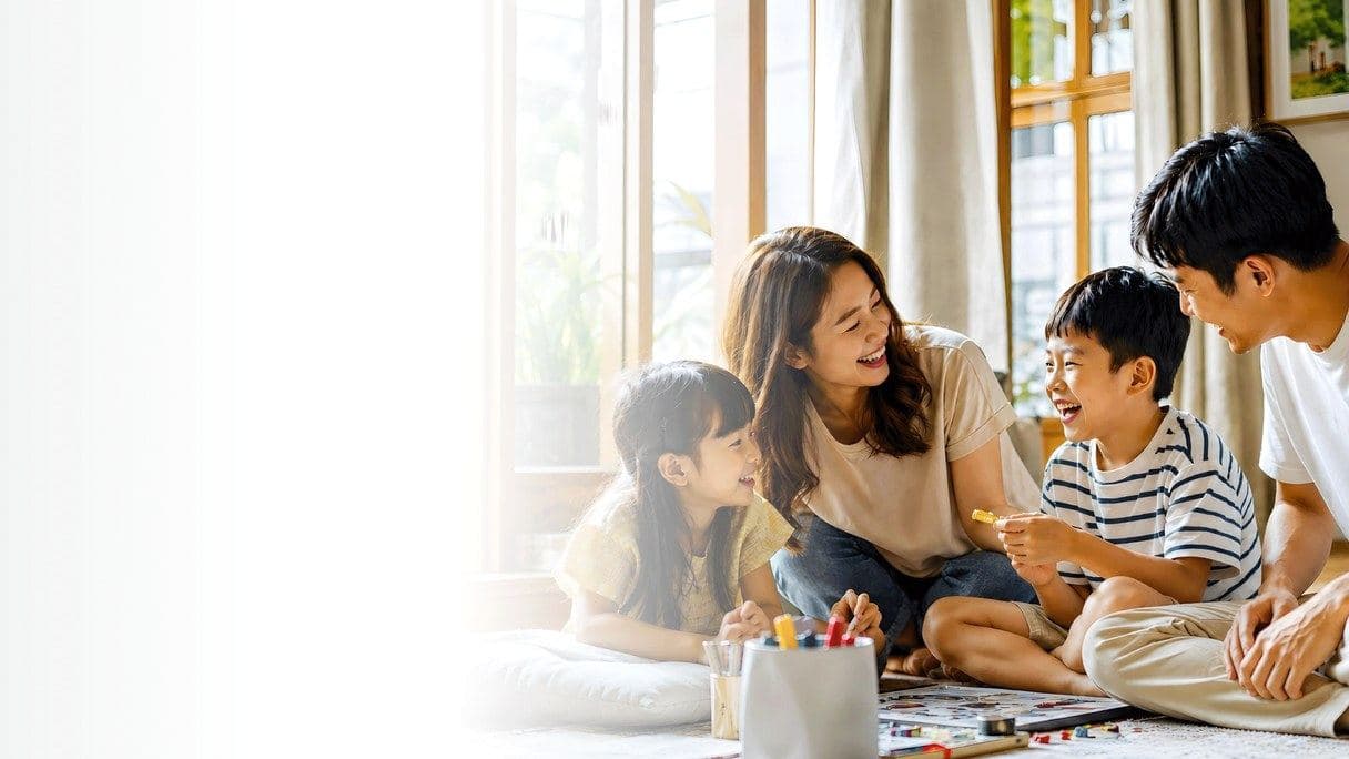 Parents and their two children playing a board game together at home
